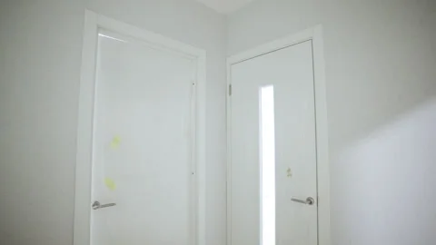 Closed doors in corner of new apartment in dwelling building Видео 330992899