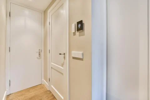 Closed doors in light corridor in flat Stock Photos