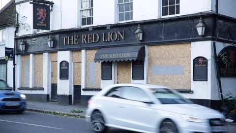 Closed down and boarded up pub in England - close up Stock Footage 79960502