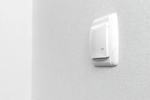 Closed electric socket mounted on wall at modern interior, copy space photo Stock Photos