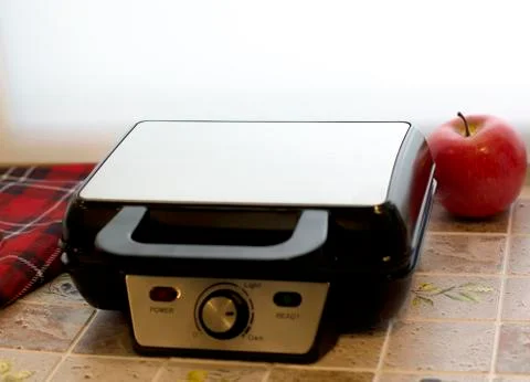 Closed Electronic waffle-iron. Sample model for a kitchen appliance. View of Stock Photos