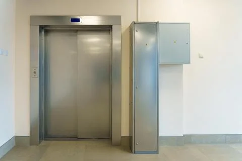 Closed elevator doors. Shiny metal elevator doors in a new modern elevator... Stock Photos