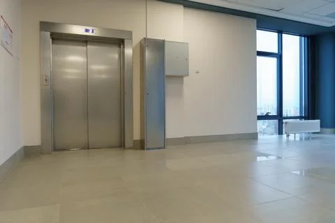 Closed elevator doors. Shiny metal elevator doors in a new modern elevator. A Stock Photos