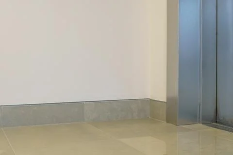 Closed elevator doors. Shiny metal elevator doors in a new modern elevator. A Stock Photos