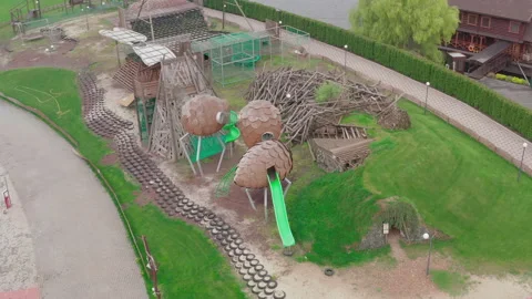 Closed empty children's colourful outside playground. pine cone slides. Video stock 153423484