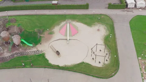 Closed empty children's colourful outside playground. pine cone slides. Video stock 153424121