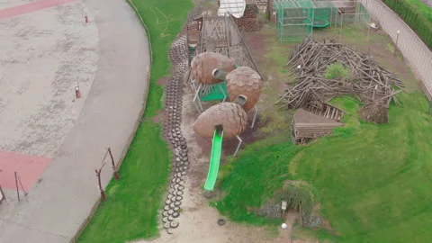 Closed empty children's colourful outside playground. pine cone slides. Video stock 153424368