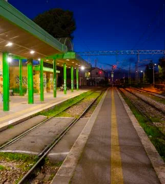 Closed evening train station, rails and red light Stock Photos