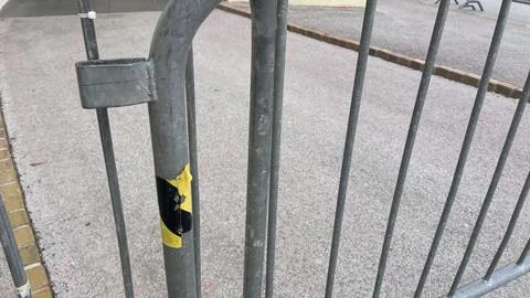 Closed gate marks the end of a vibrant event space 库存照片