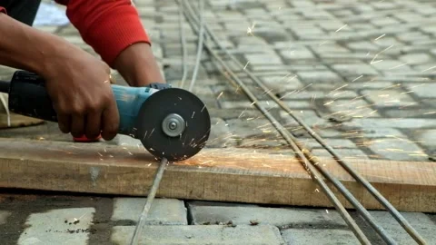 Closed up of hands cutting iron using an electric grinder Stock-Footage 277442150