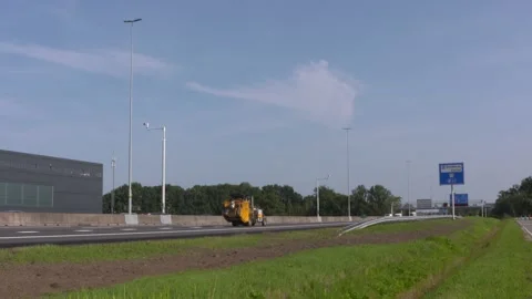 Closed highway - machine applying road markings - traffic in opposite direction Stock Footage 139813983