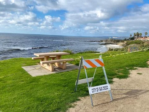 Closed La Jolla Beach with informative signage during COVID-19 pandemic. Stock Photos