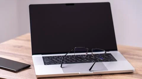 Closed laptop with dark screen Stock Photos