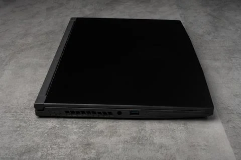 Closed laptop on grey surface Foto stock