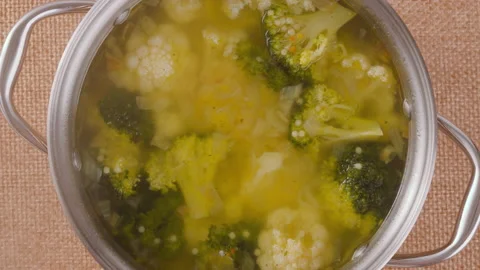 Closed lid cooking pan of vegetable soup close-up Stock Footage 230564258