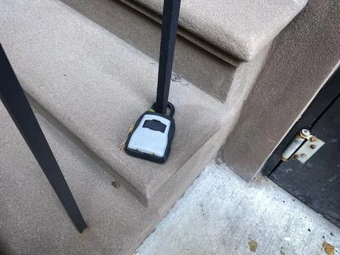 Closed lock on cement step fastened around a steel bar Fotos de archivo