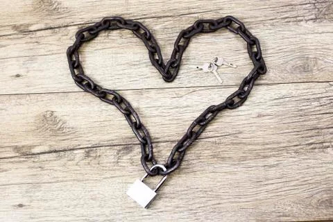 The closed lock with keys shaped chain heart. Stock Photos