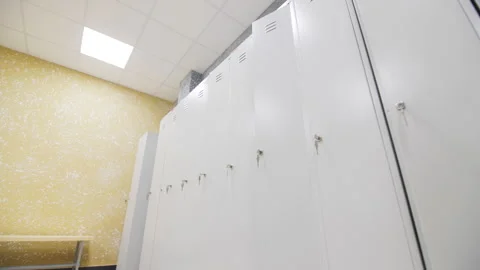 Closed metal cabinets with keys in gym locker room Stock Footage 242903553