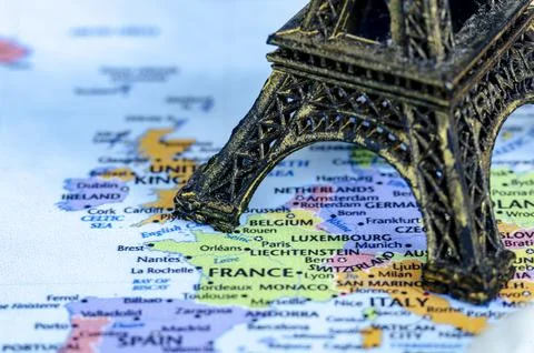 Closed up of miniature Eiffel Tower placed on a world map. Travel destinati.. Stock Photos