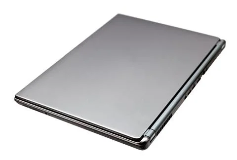 Closed notebook computer on white background Stock Photos