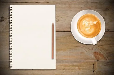 Closed notebook with cup of coffee Stock Photos