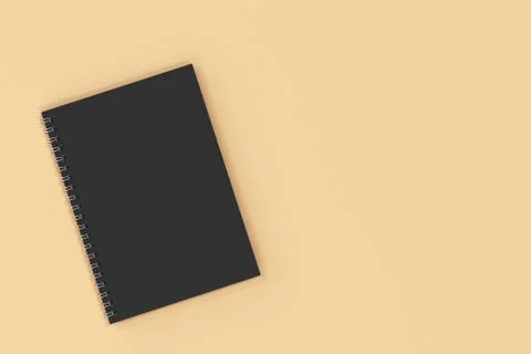 Closed notebook spiral bound on orange background Illustrazione stock