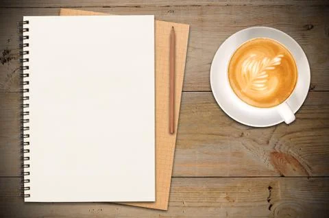 Closed notebooks with cup of coffee Stock Photos