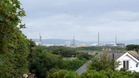 Closed nuclear power station site in Sellafield through rooftops 動画素材 253991576
