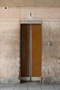 Closed old Soviet wooden elevator doors in the old interior Stock Photos