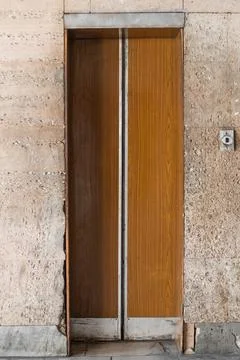 Closed old Soviet wooden elevator doors in the old interior  Stock Photos