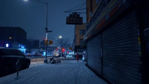 Closed pharmacy storefront on snowy urban street in New York at night Stock Footage 342332214