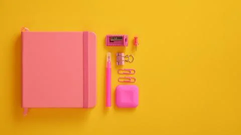 Closed pink notebook with felt-tip pen, sharpener, paper clips and eraser. .. Stock Photos
