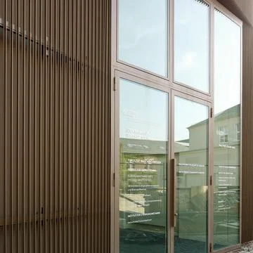 Closed plastic blinds on the window with the reflection in the glass Stock Photos