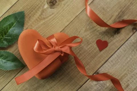 Closed red box in the shape of a heart with a red ribbon bow Stock Photos