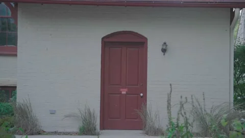 Closed red door on a historic brick building near Grosse Point Lighthouse. Stock Footage 326716189