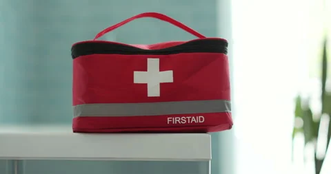 Closed red first aid kit bag at home, box object close up. Life saving, medical Video stock 308935818