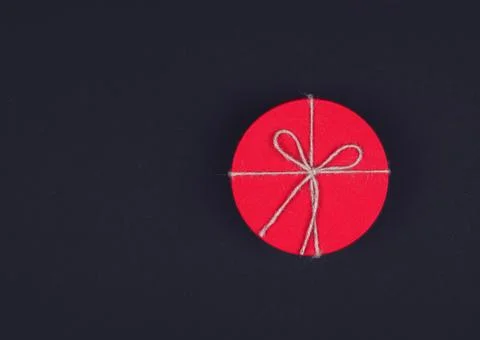 Closed red round gift box on black background. Top view. Gift for the holiday Stock Photos
