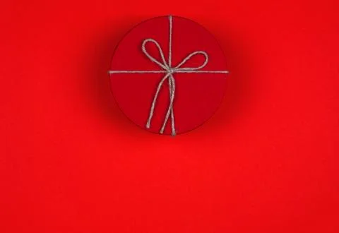 Closed red round gift box on red background. Top view. Gift for the holidays  Stock Photos