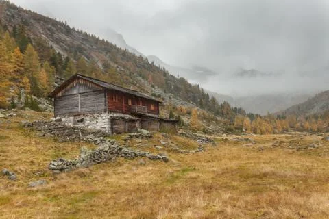 A closed refuge at fall in front of a mountain meadow Stock Photos