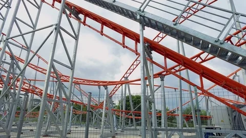 Closed Roller Coaster ride on a cloudy day in an amusement park Stock Footage 71956245