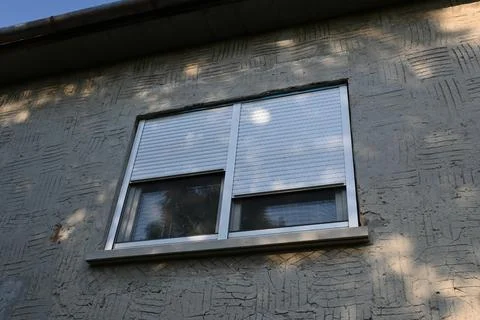 Closed roller shutters helping keep a home cool in summer Stock Photos