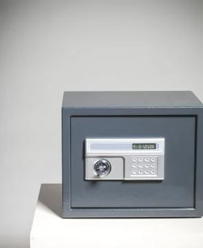 Closed safe on grey background 스톡 사진