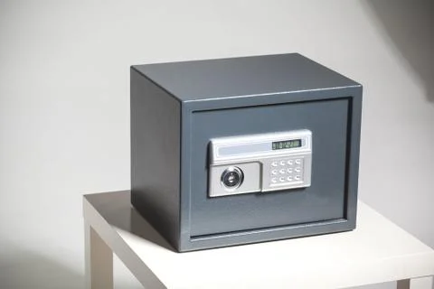 Closed safe on grey background 스톡 사진