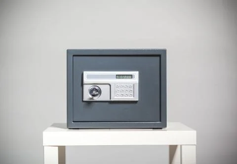 Closed safe on grey background Stock Photos