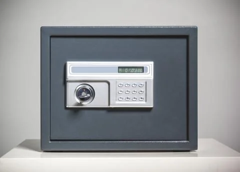 Closed safe on grey background 스톡 사진