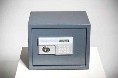 Closed safe on grey background 写真素材