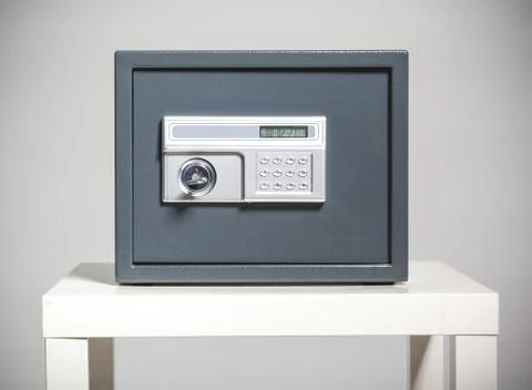 Closed safe on grey background Stock Photos