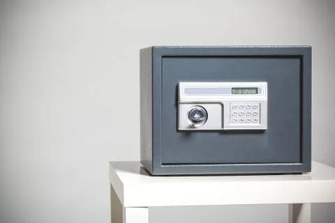 Closed safe on grey background 스톡 사진