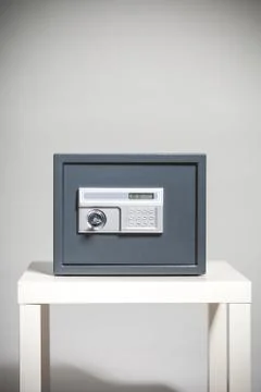 Closed safe on grey background Stock Photos