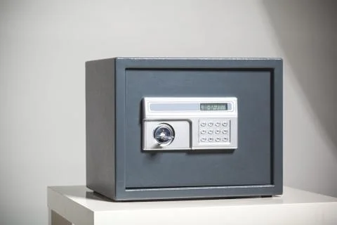 Closed safe on grey background Stock Photos